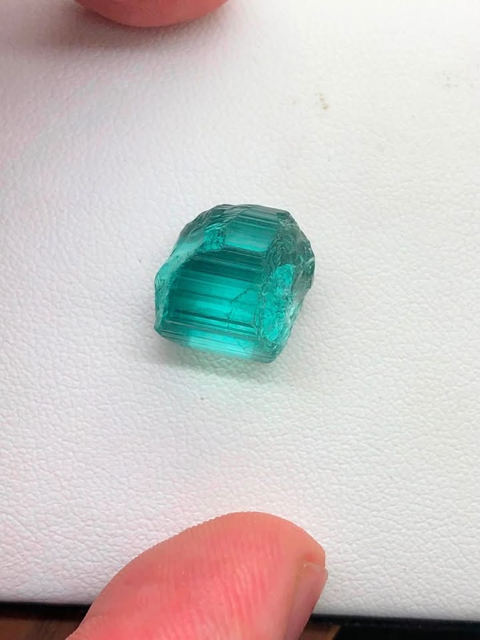 An Ethiopian tourmaline crystal being examined by hand