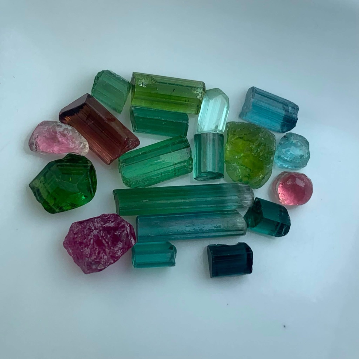A parcel of rough Ethiopian tourmaline in a range of colours, including green, pink, teal and blue